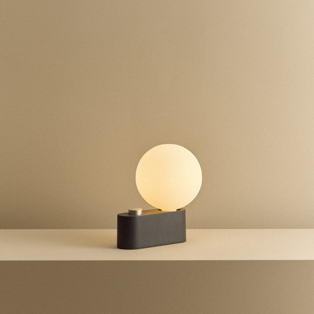 Tala Alumina Multi-Use Lamp in Charcoal shown illuminated