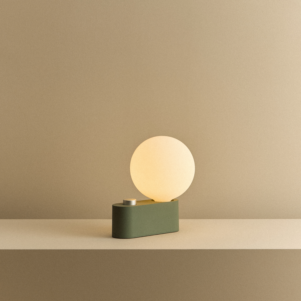 Tala Alumina Multi-Use Lamp in Sage shown illuminated