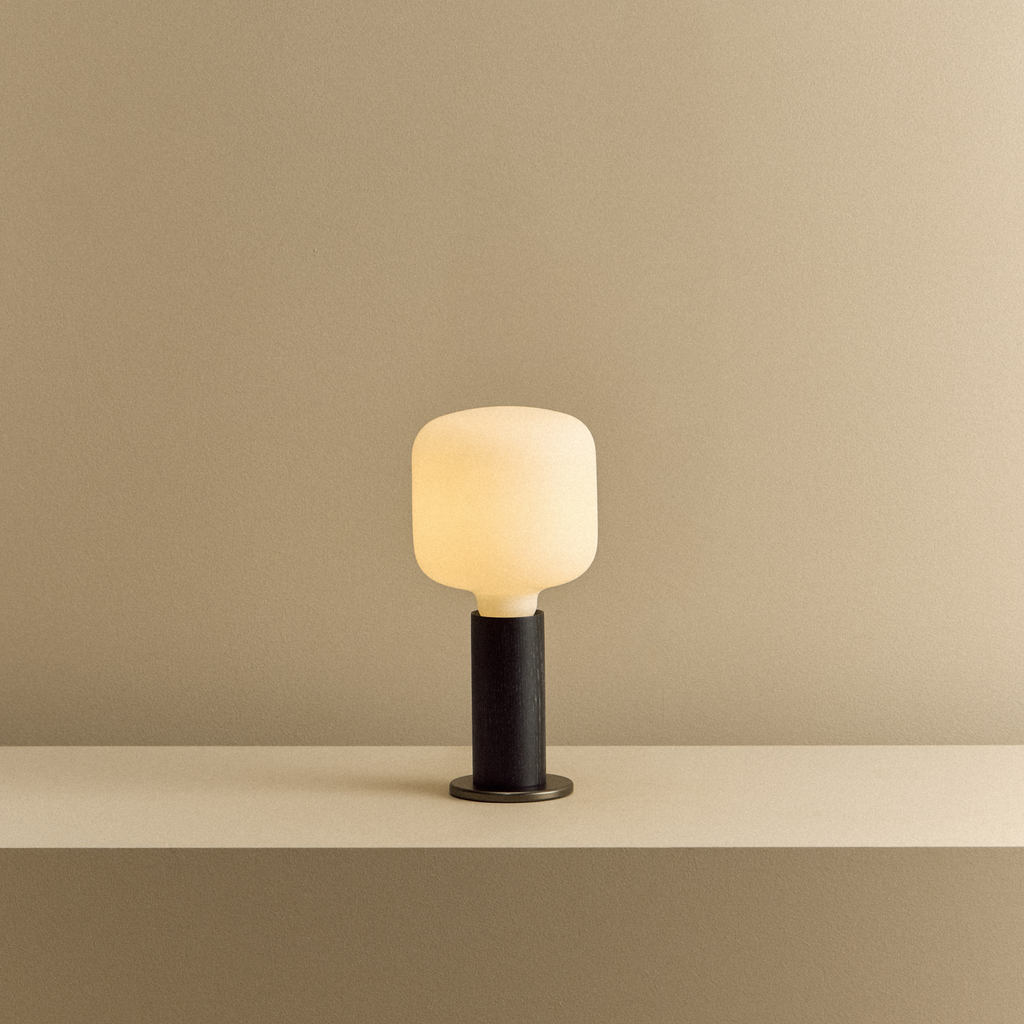 Tala Knuckle Table Lamp in Blackened Oak + Oblo shown illuminated