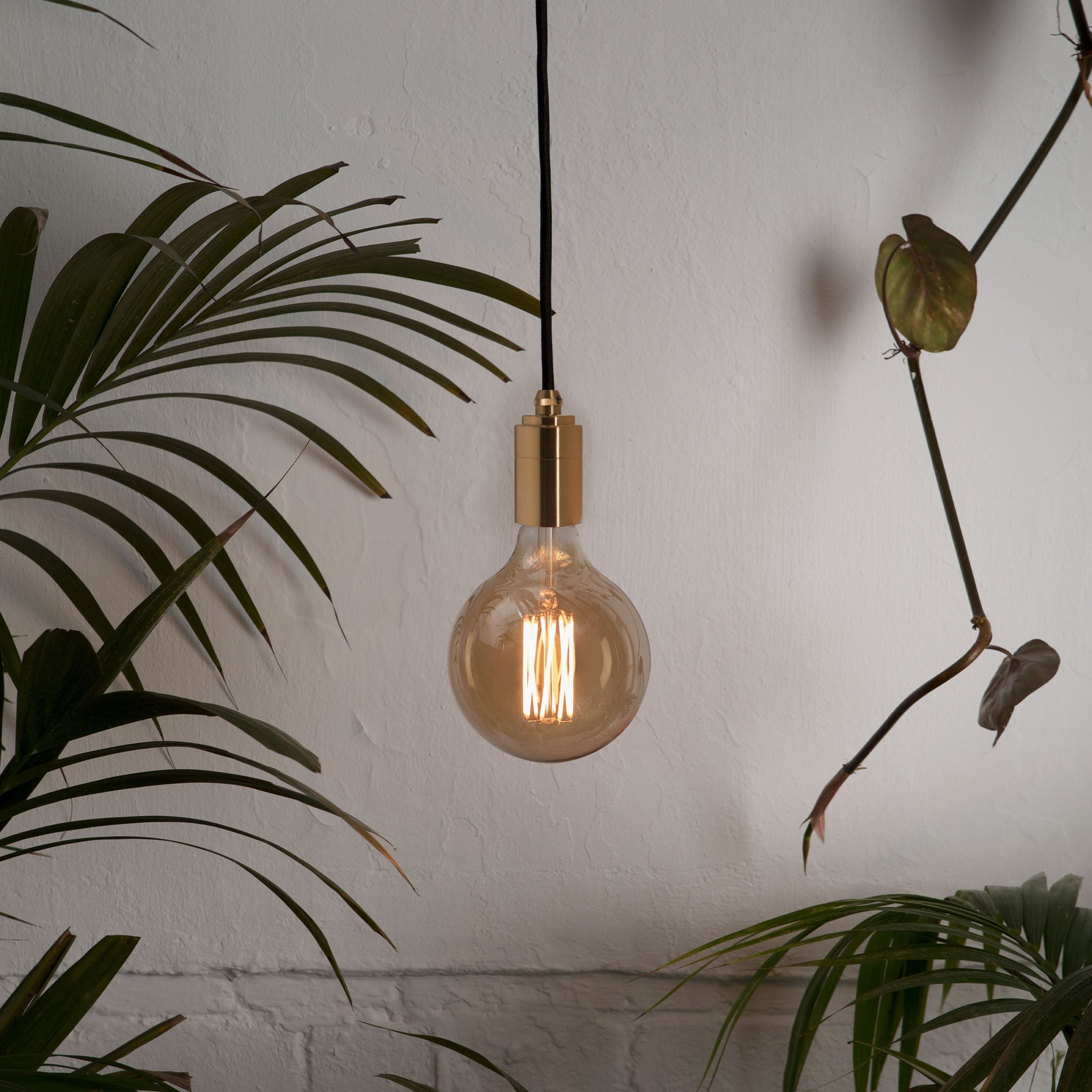 Tala Gaia Plug-In Pendant in Brass in a styled interior setting