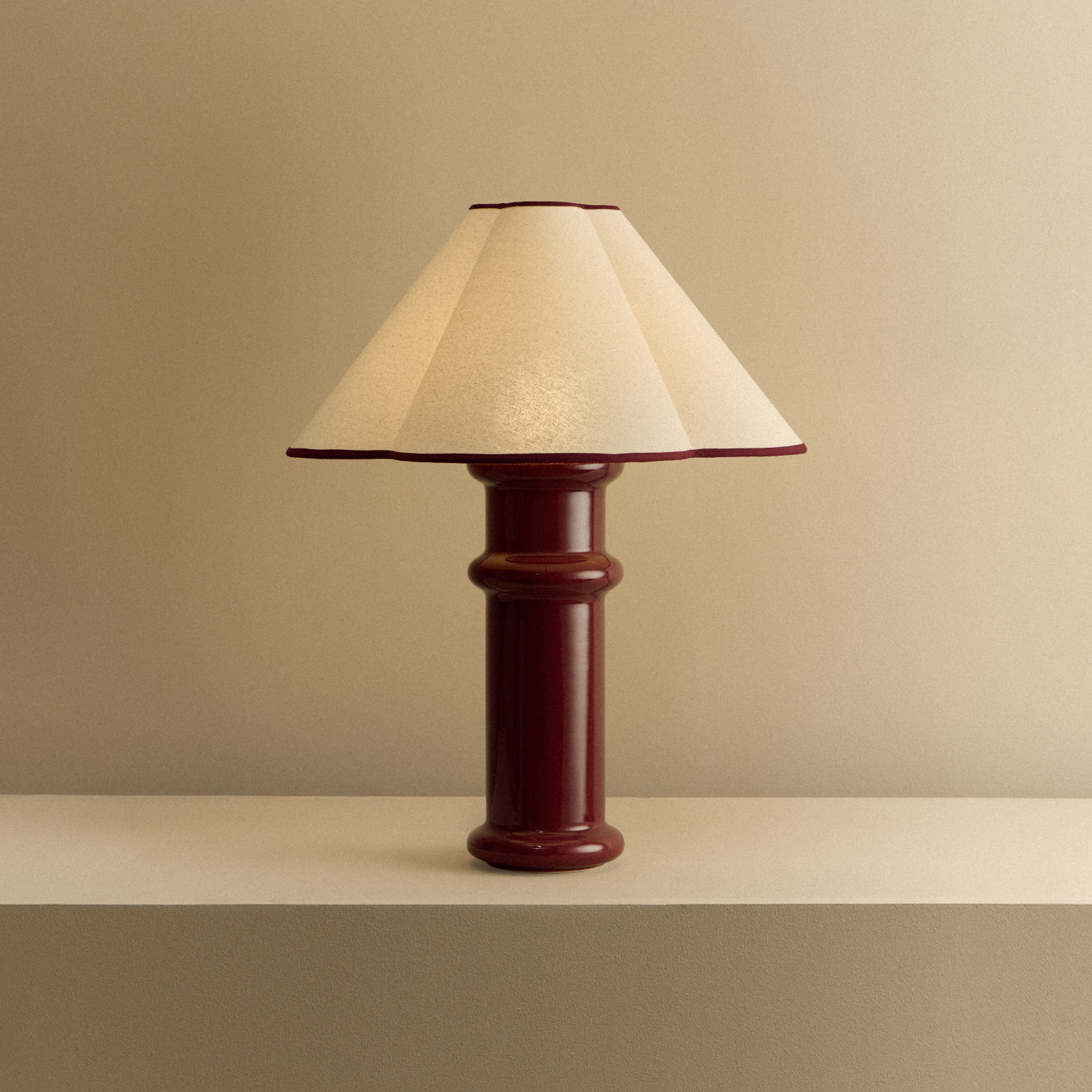 Tala Heath Table Lamp in Port Red shown illuminated
