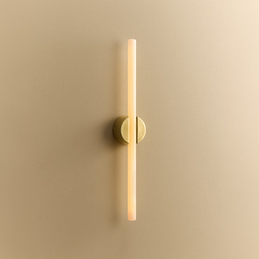 Tala Kilter 1.0 Wall Light in Solid Brass shown illuminated