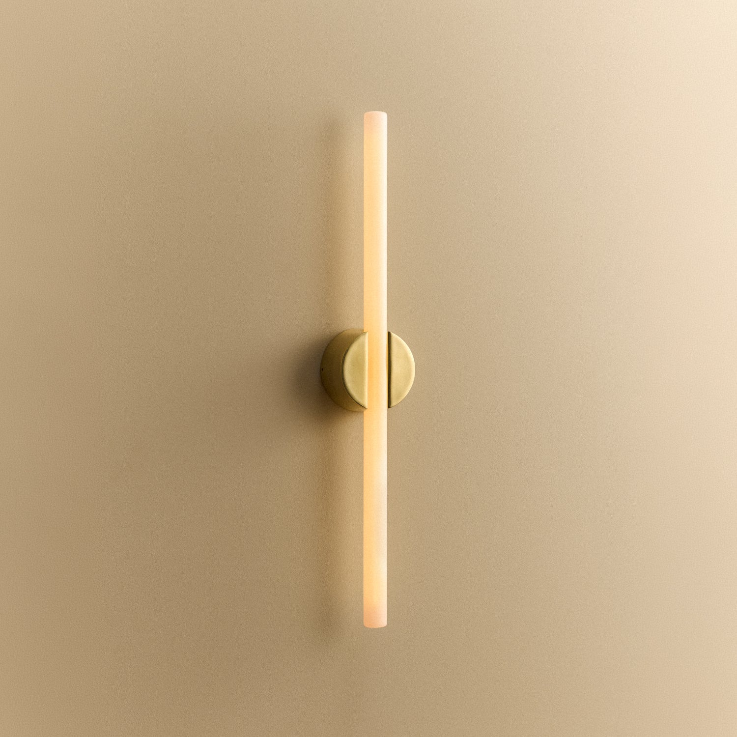 Tala Kilter 1.0 Wall Light in Solid Brass shown illuminated