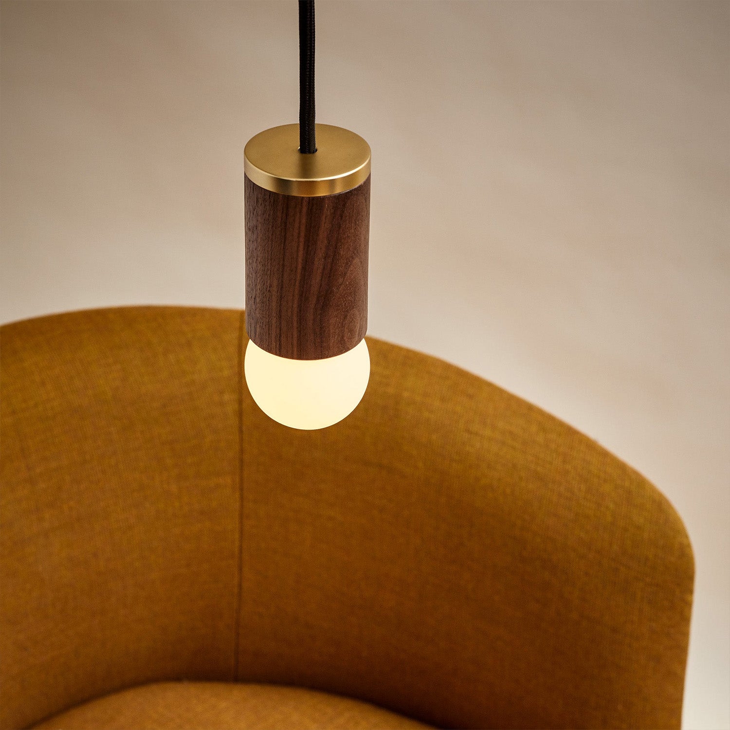 Tala Knuckle Pendant in Walnut in a styled interior setting