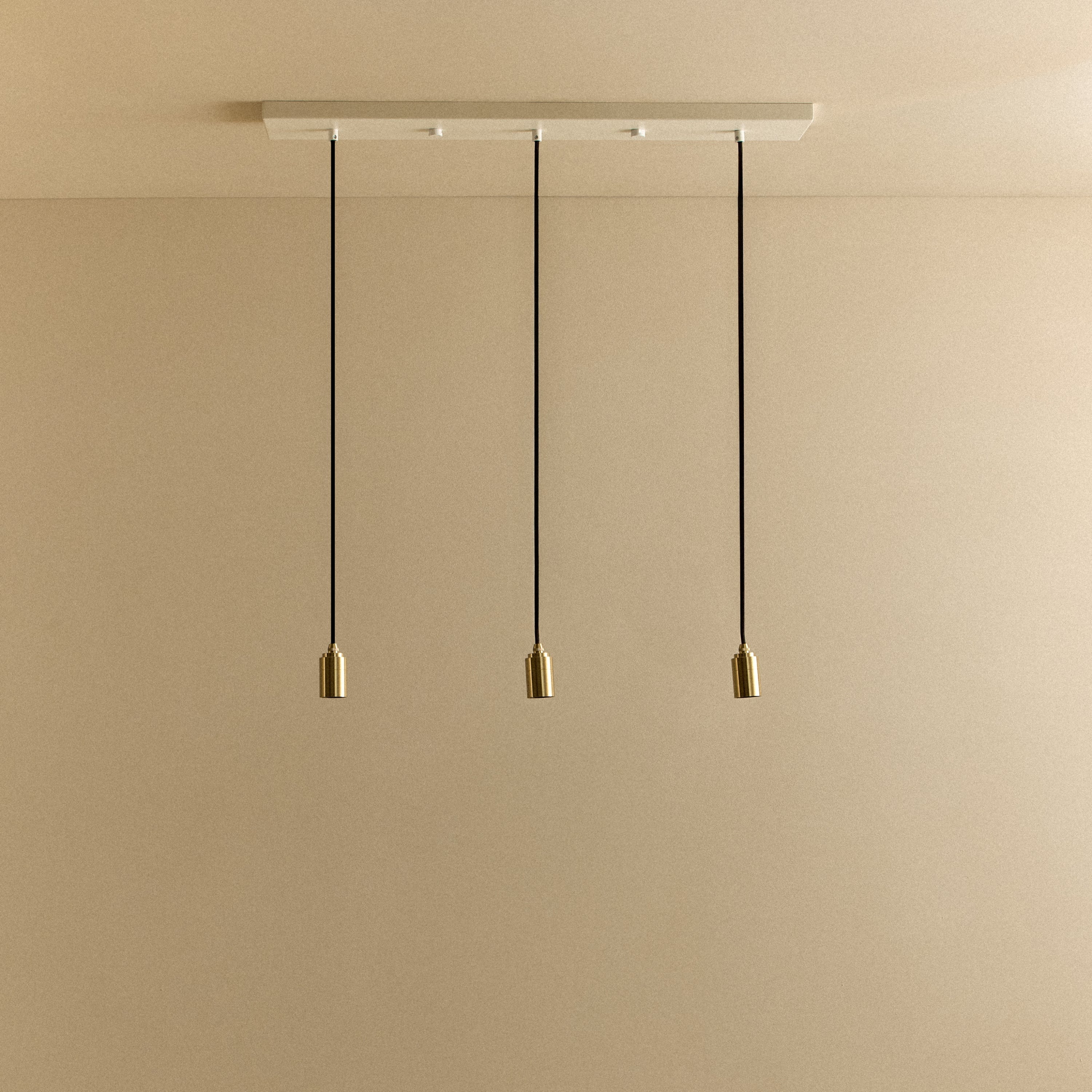 Tala Linear Triple Pendant in Brass fixture shown without a bulb