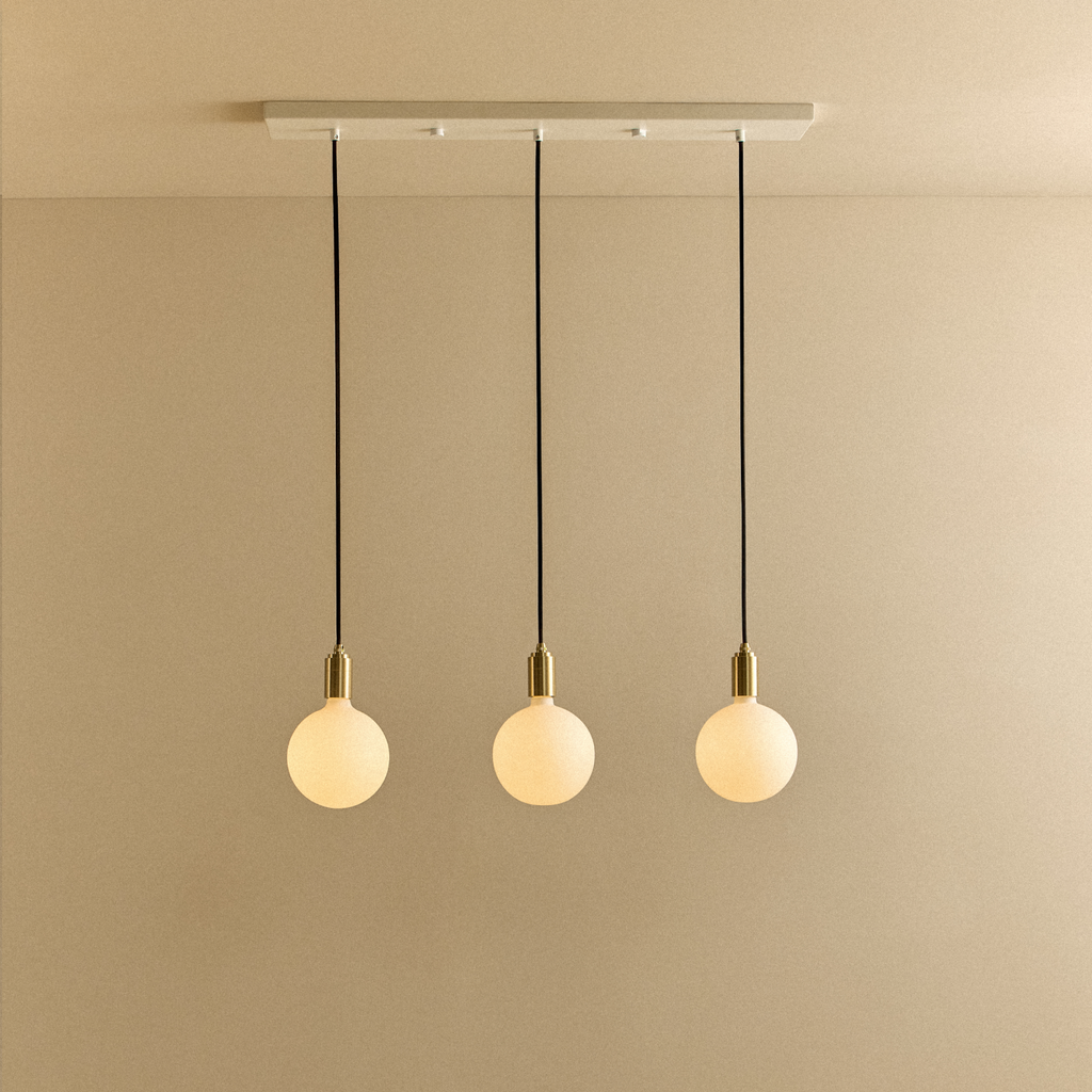 Tala Linear Triple Pendant in Brass + Sphere IV shown illuminated