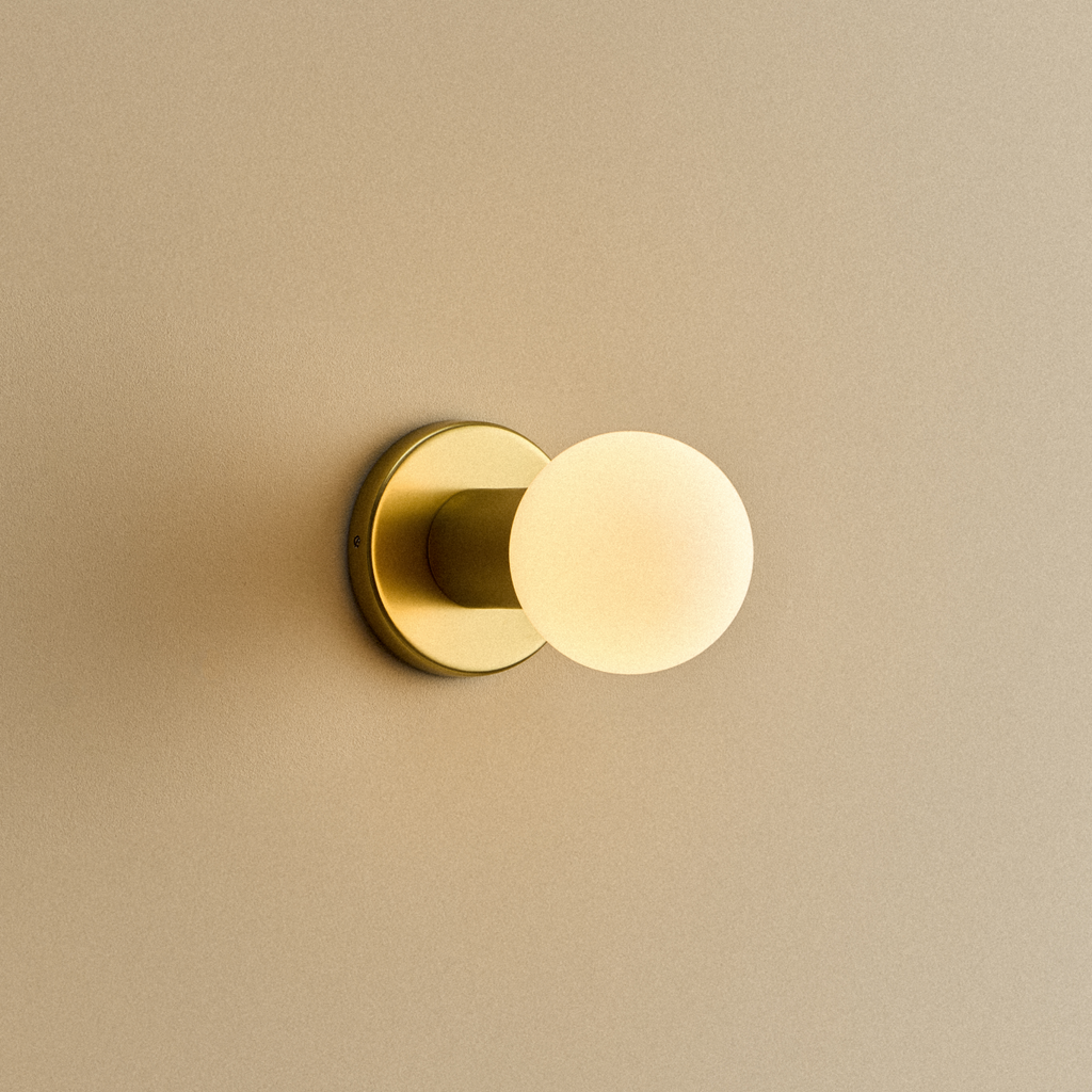 Tala Lochan Wall Light in Brass + Sphere III shown illuminated