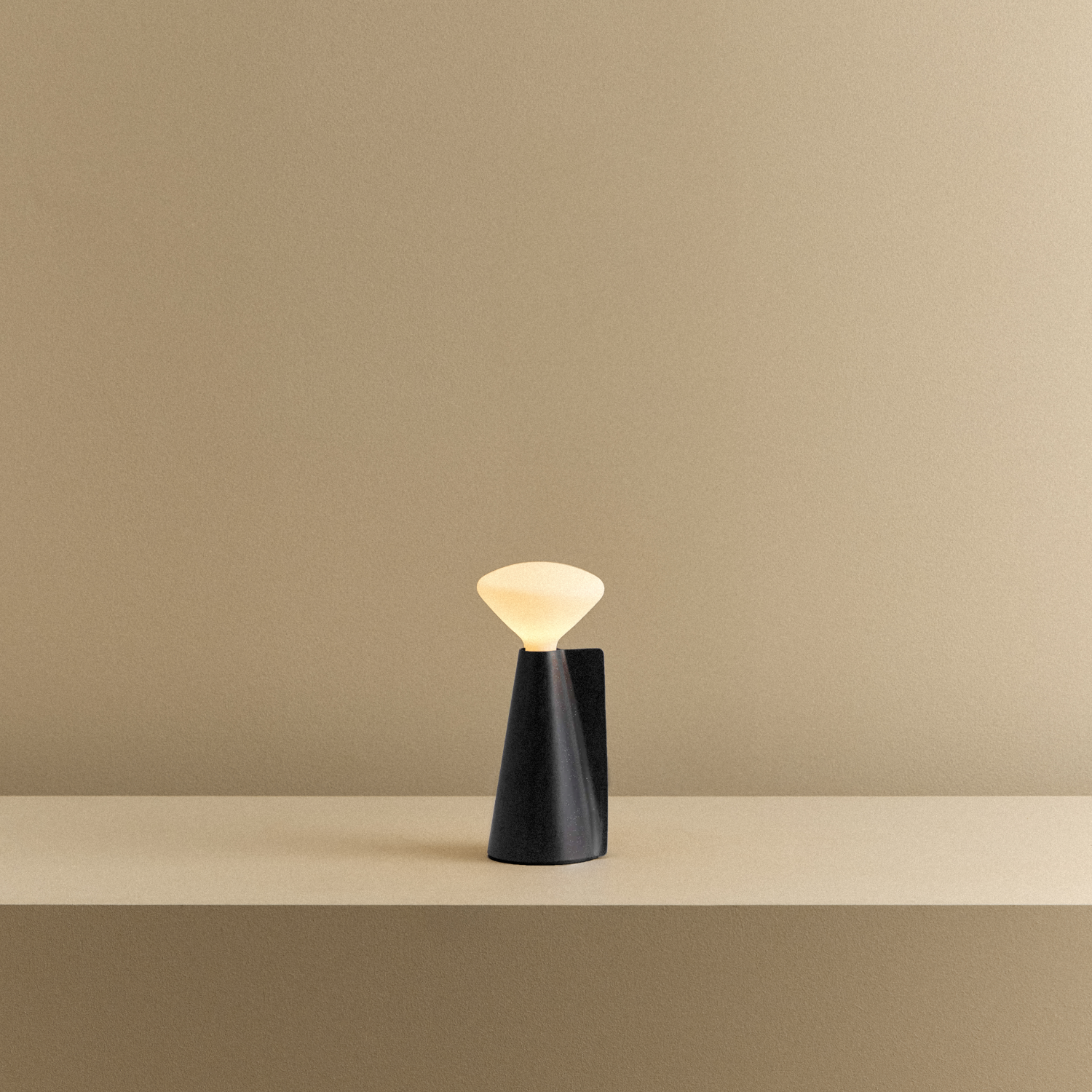 Tala Mantle Portable Lamp in Granite Black shown illuminated