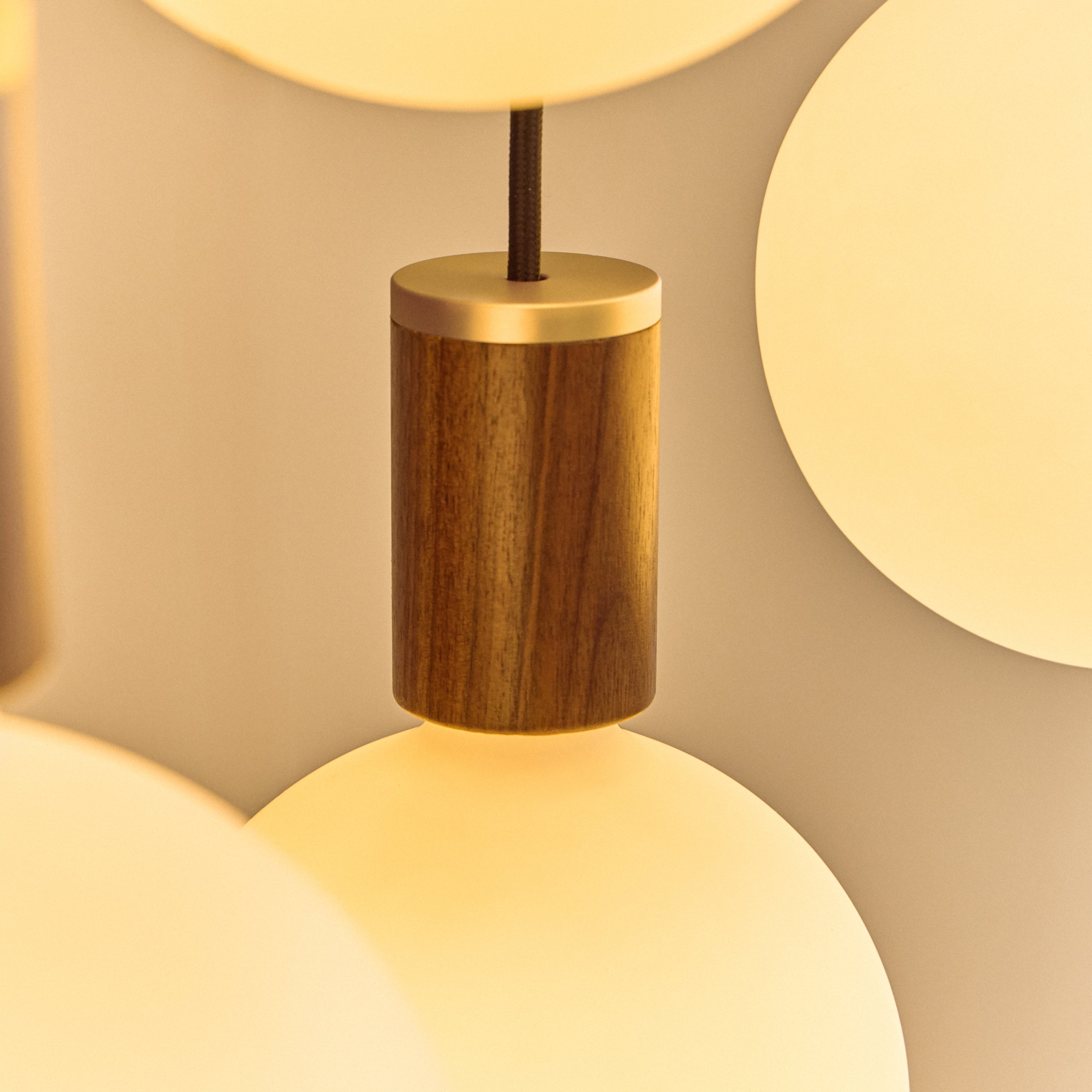 Tala Oval Dim-to-Warm Pendant Light in Walnut close-up detail of the finish