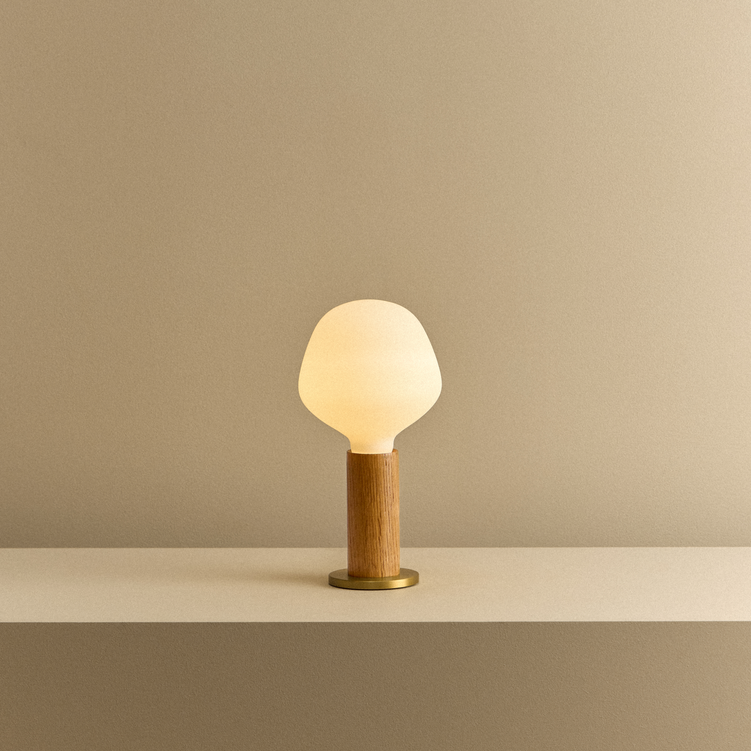 Tala Knuckle Table Lamp in Oak + Enno shown illuminated