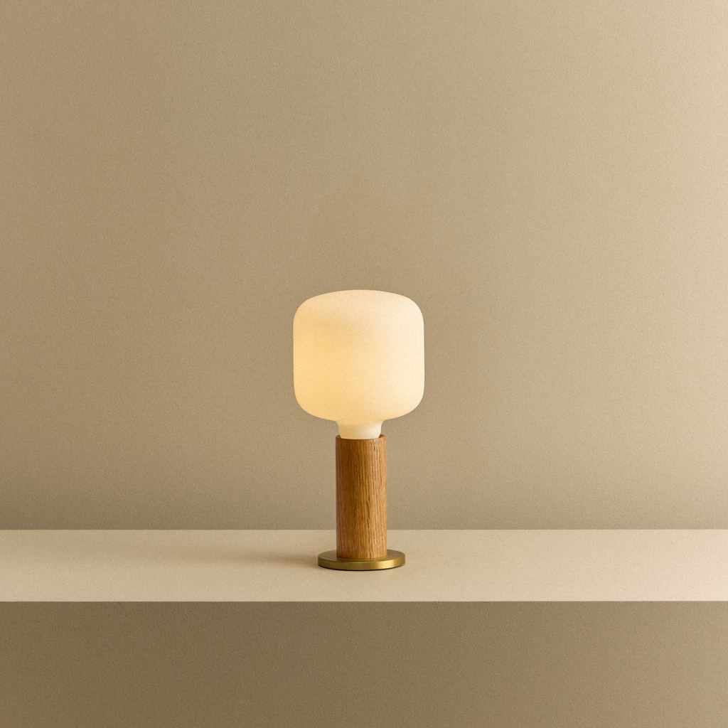 Tala Knuckle Table Lamp in Oak + Oblo shown illuminated