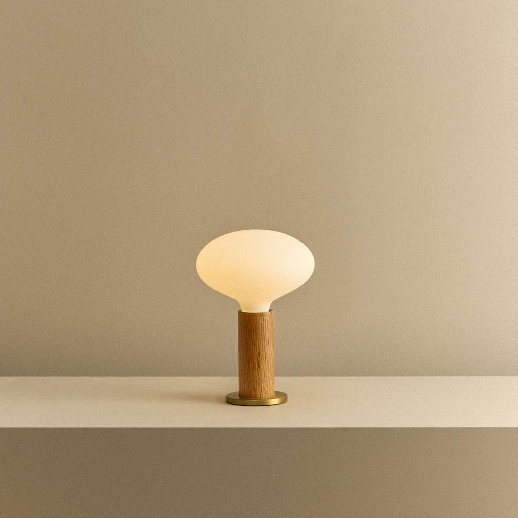 Tala Knuckle Table Lamp in Oak + Oval shown illuminated