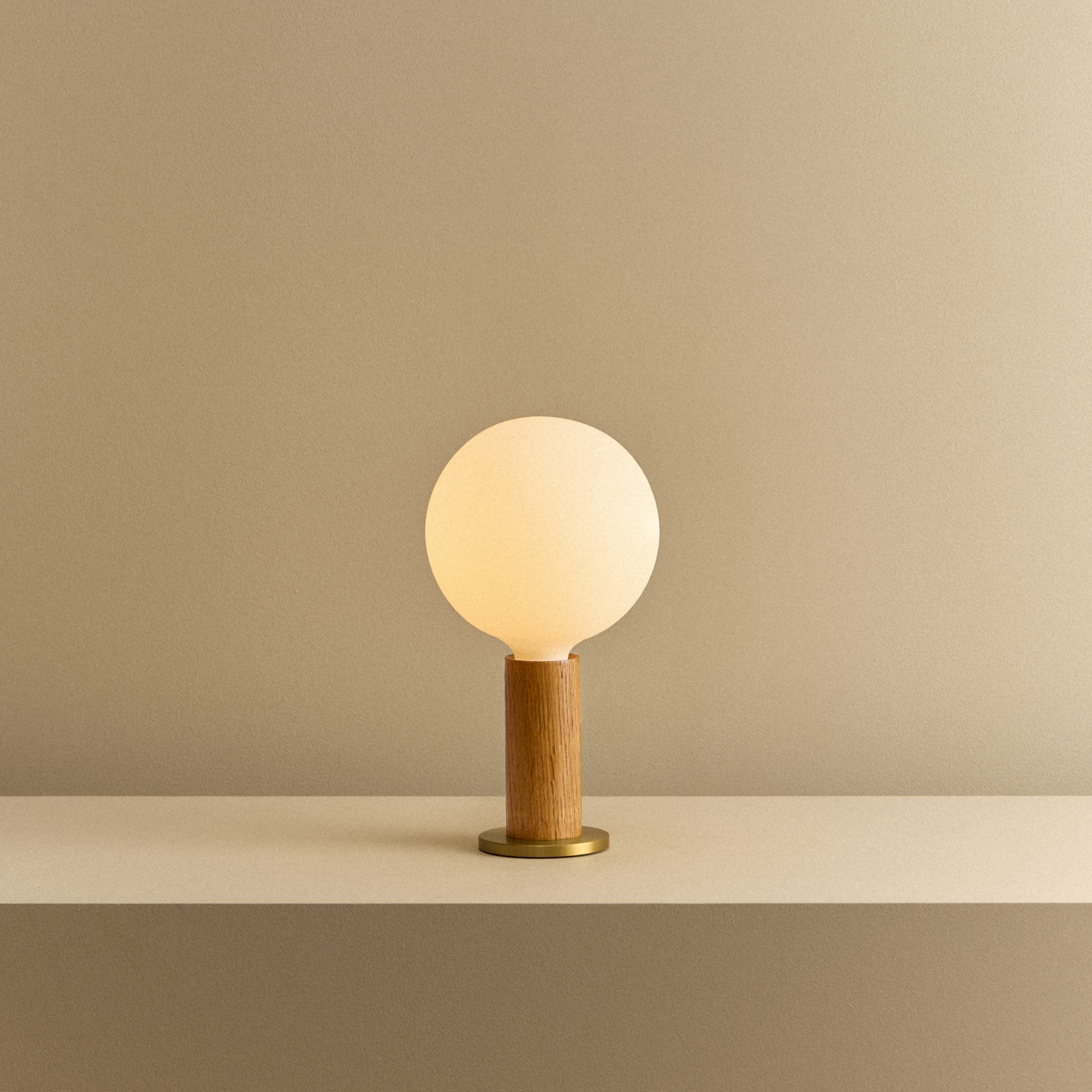 Tala Knuckle Table Lamp in Oak + Sphere IV shown illuminated