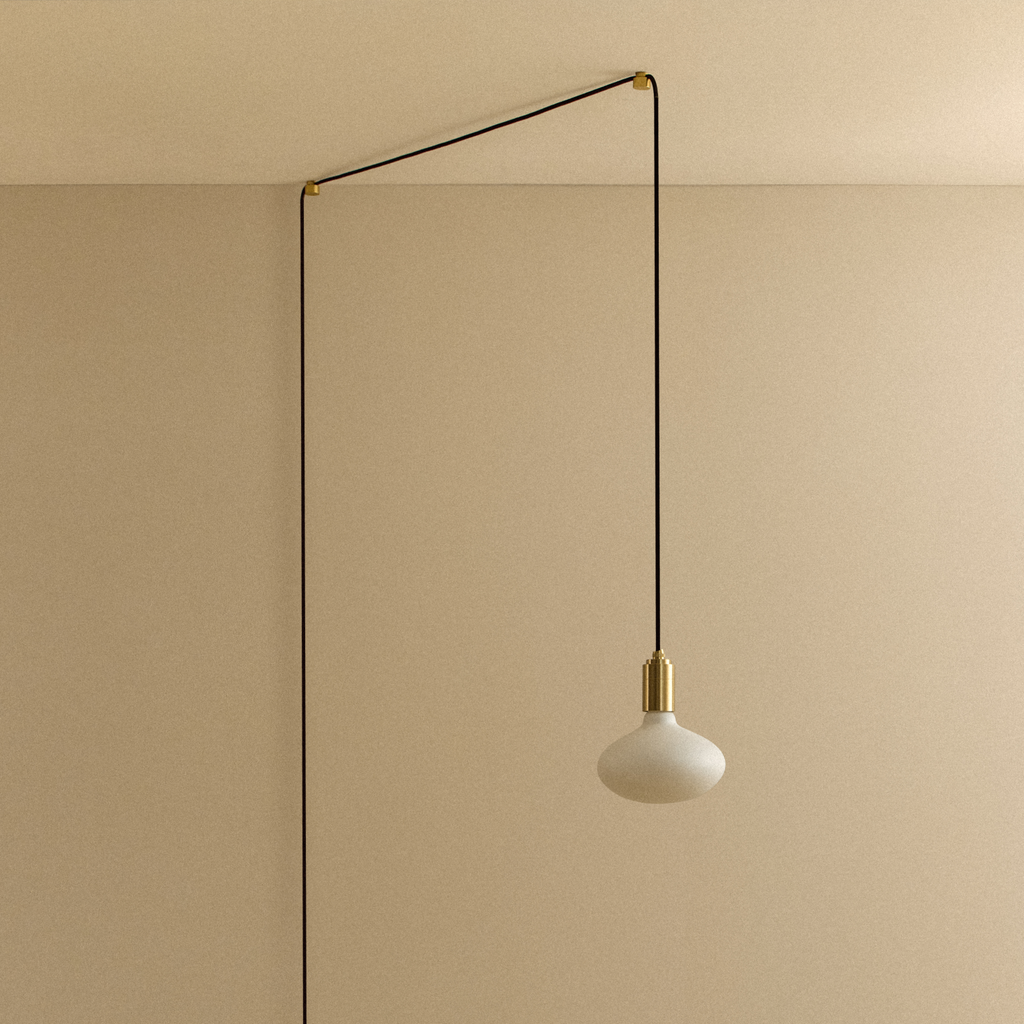 Tala Oval Dim-to-Warm Plug-In Pendant in Brass shown unlit