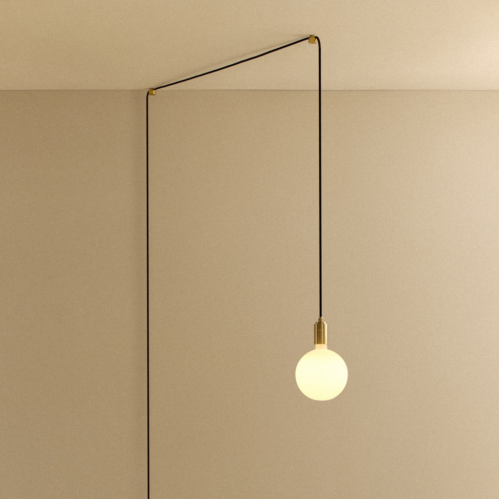 Tala Sphere IV Plug-In Pendant in Brass shown illuminated