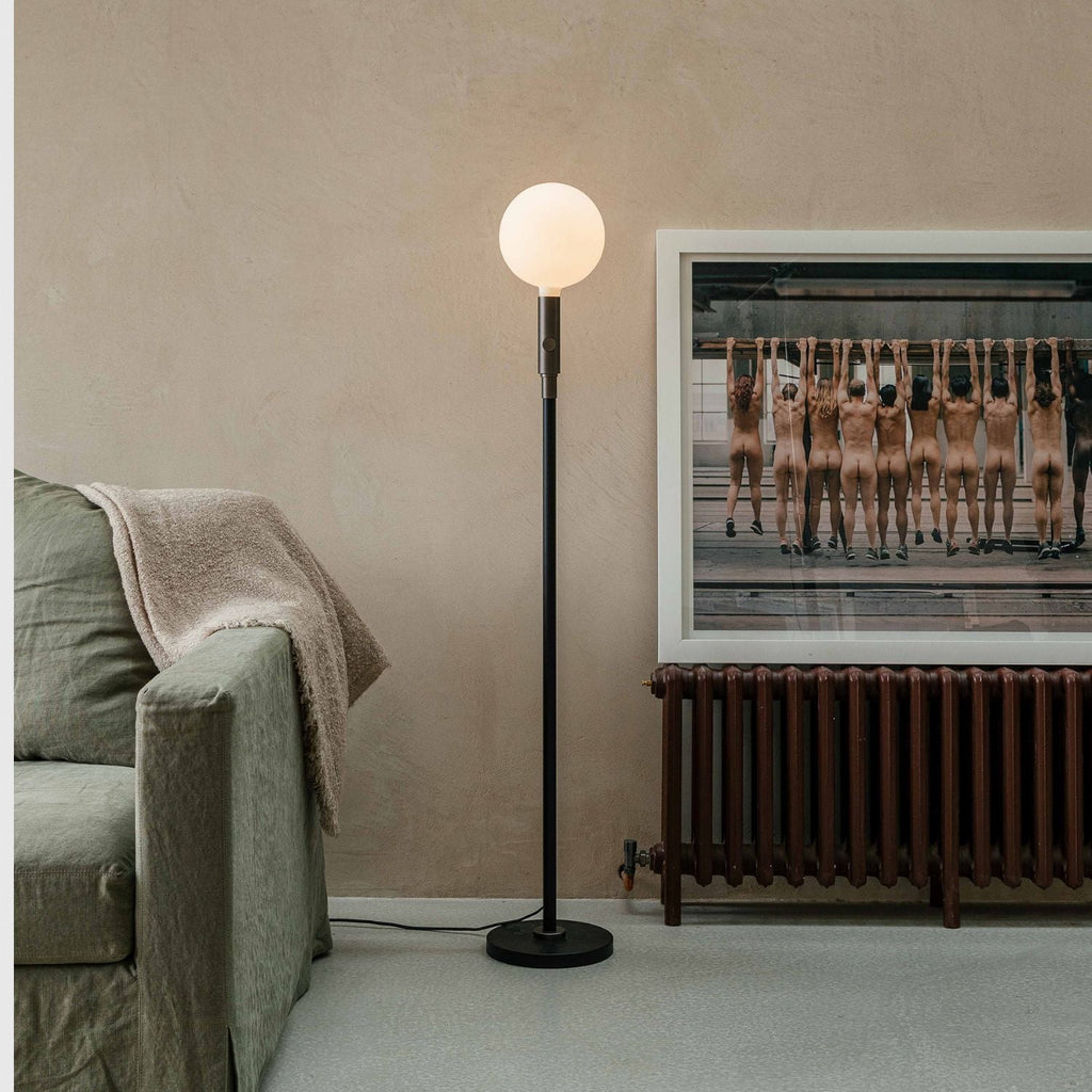 Tala Poise Adjustable Floor Lamp in Graphite in a styled interior setting