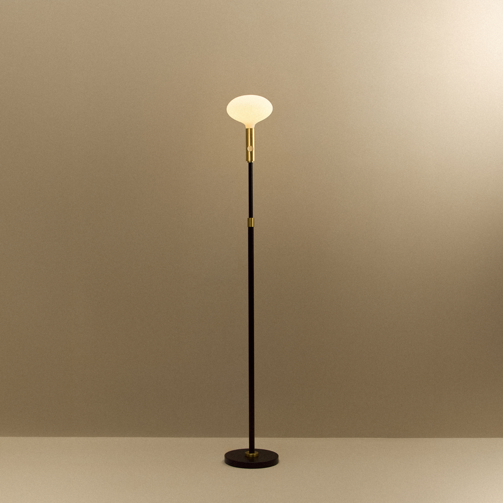 Tala Poise Adjustable Floor Lamp in Brass + Oval II shown illuminated