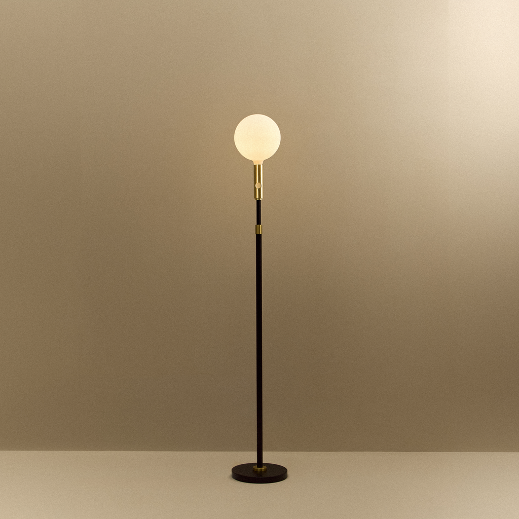 Tala Poise Adjustable Floor Lamp in Brass + Sphere V shown illuminated (view 2)