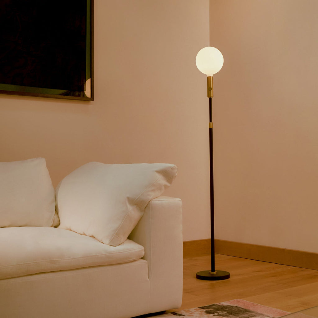Tala Poise Adjustable Floor Lamp in Brass + Sphere V in a styled interior setting (view 2)