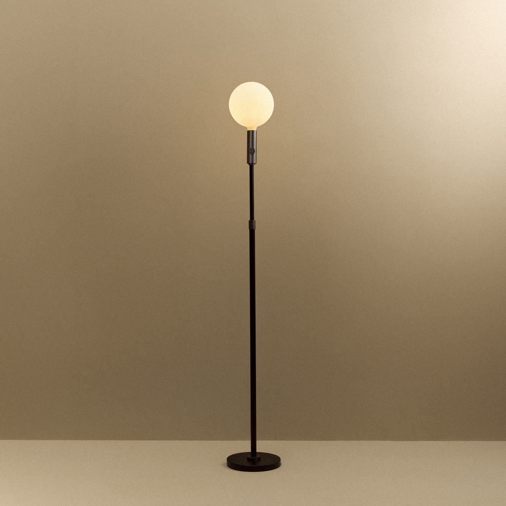 Tala Poise Adjustable Floor Lamp in Graphite + Sphere V shown illuminated