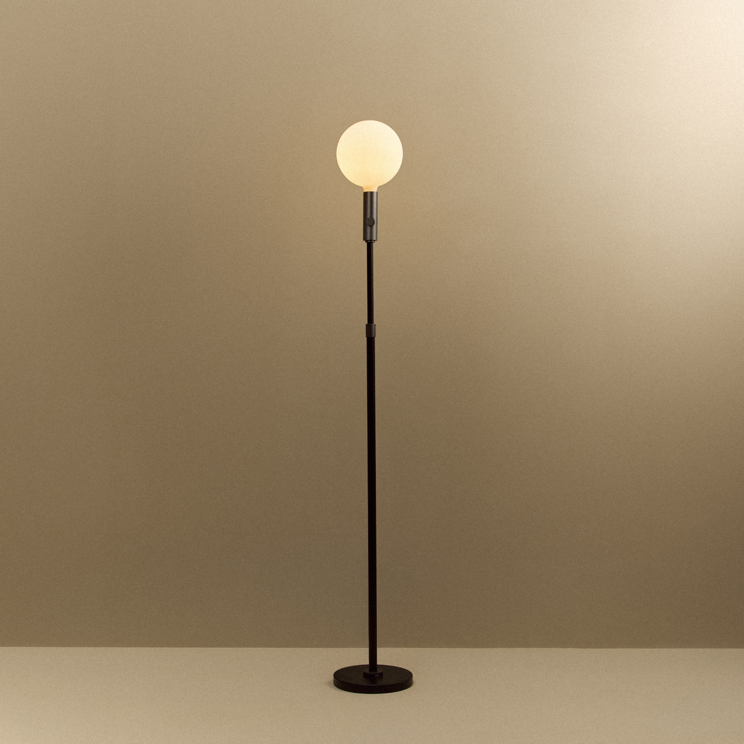 Tala Poise Adjustable Floor Lamp in Graphite + Sphere V shown illuminated