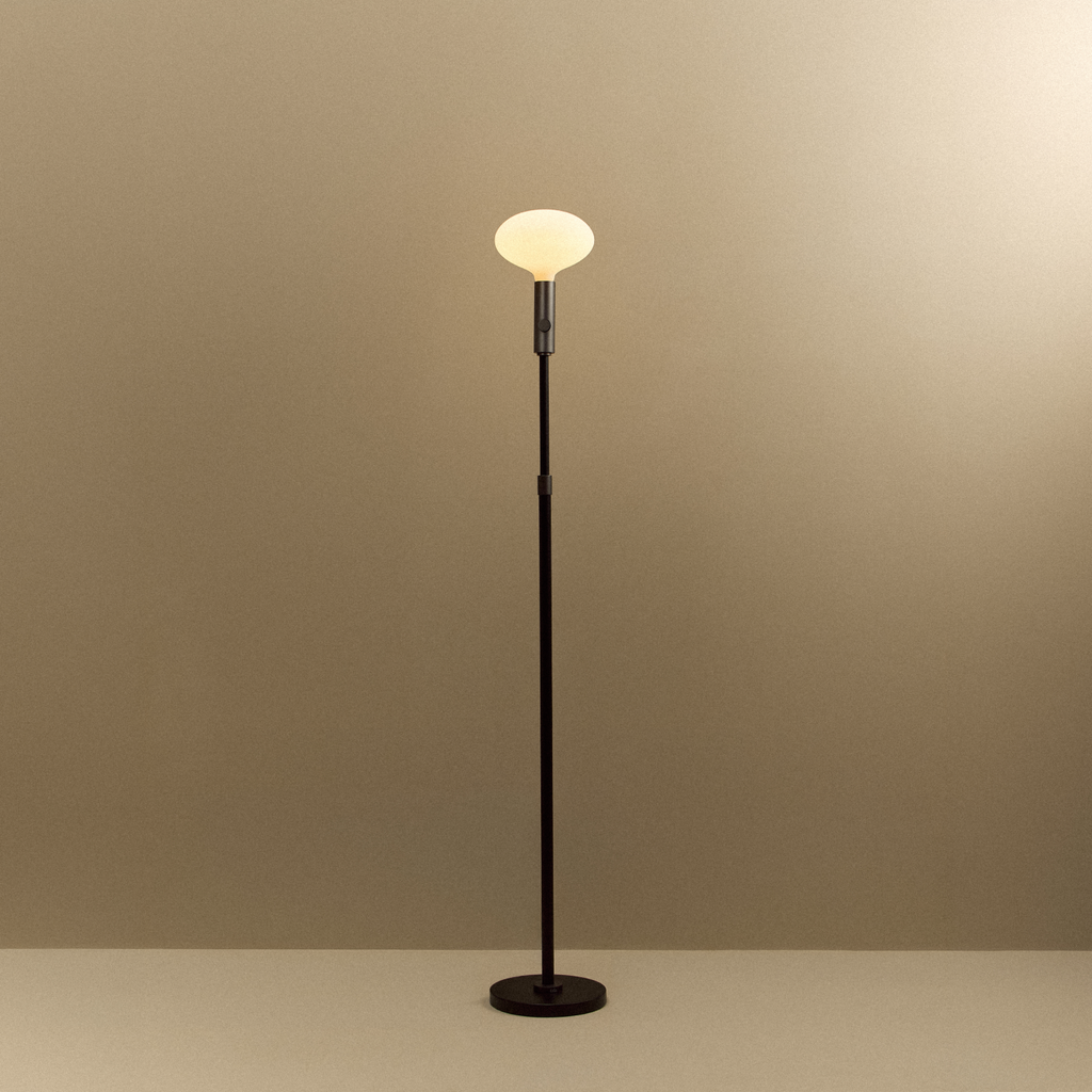 Tala Poise Adjustable Floor Lamp in Graphite + Oval II shown illuminated