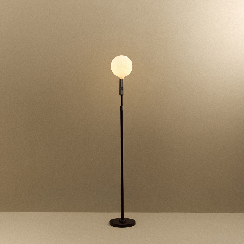 Tala Poise Adjustable Floor Lamp in Graphite + Sphere V shown illuminated (view 2)