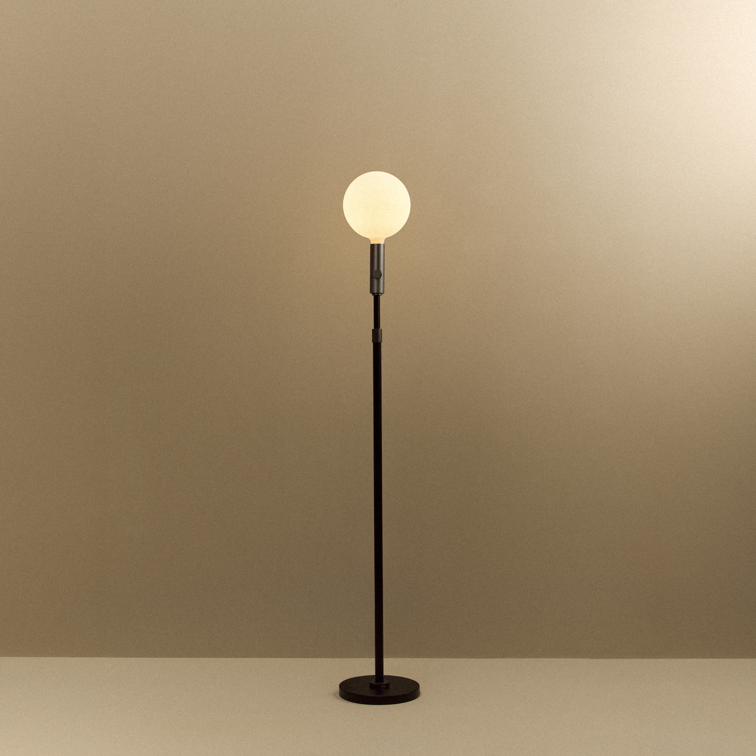 Tala Poise Adjustable Floor Lamp in Graphite + Sphere V shown illuminated (view 2)
