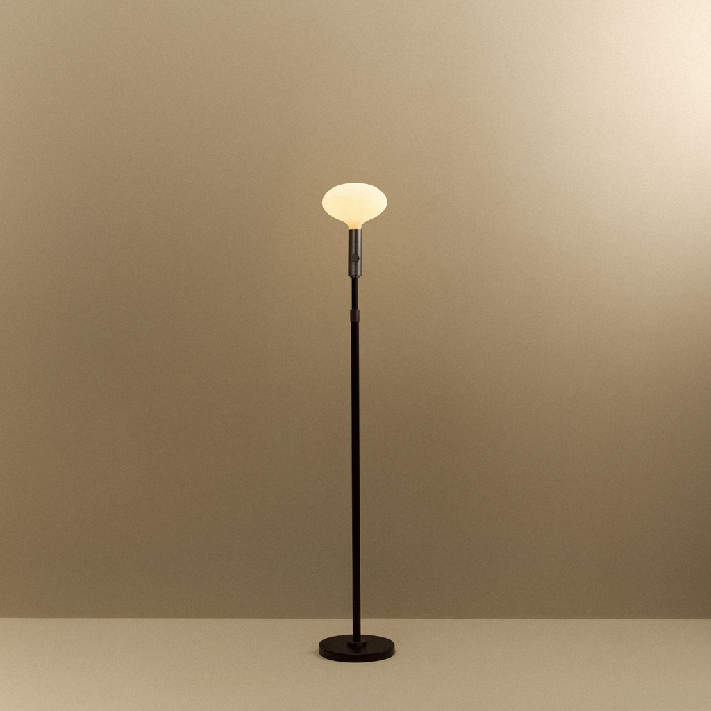 Tala Poise Adjustable Floor Lamp in Graphite + Oval II shown illuminated (view 2)