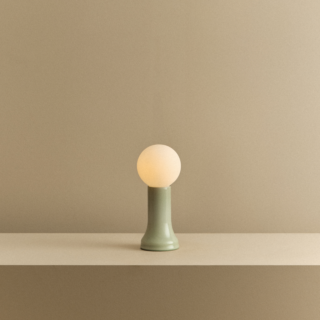Tala Shore Table Lamp in Sea Green shown illuminated