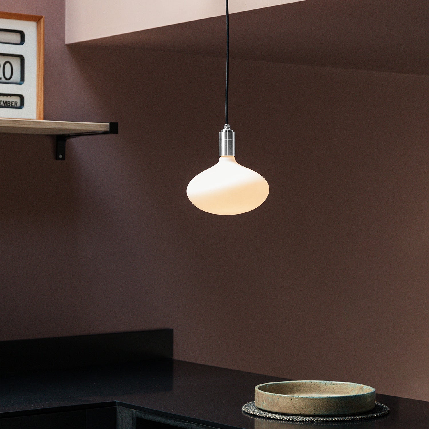 Tala Oval II Pendant Light in Stainless Steel in a styled interior setting