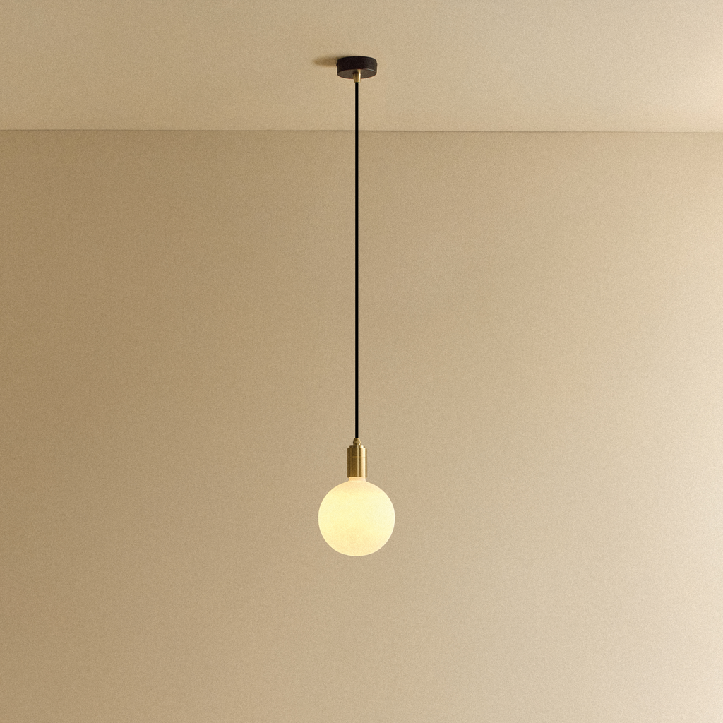 Tala Sphere IV Pendant Light in Brass shown illuminated