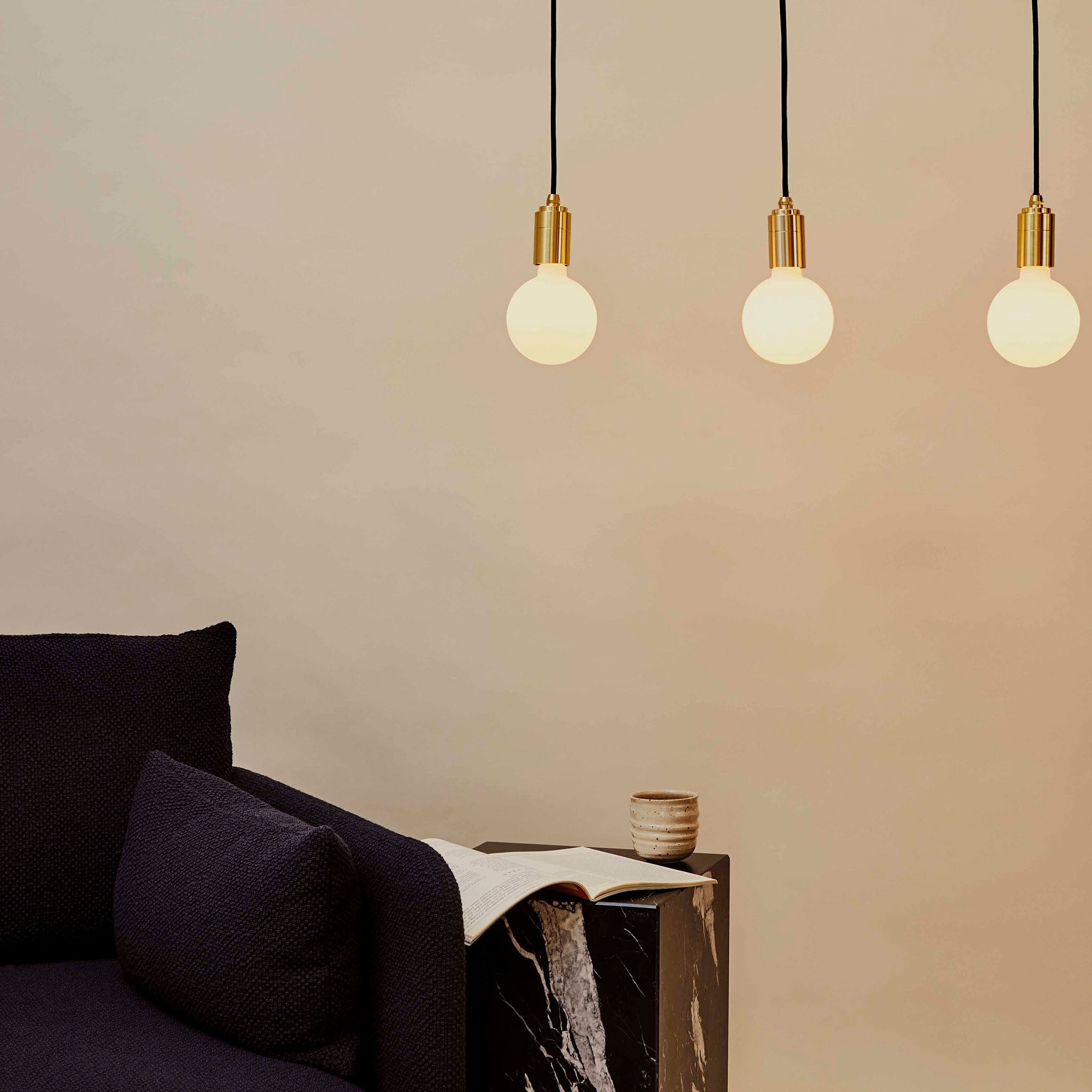 Tala Sphere III Pendant Light in Brass in a styled interior setting