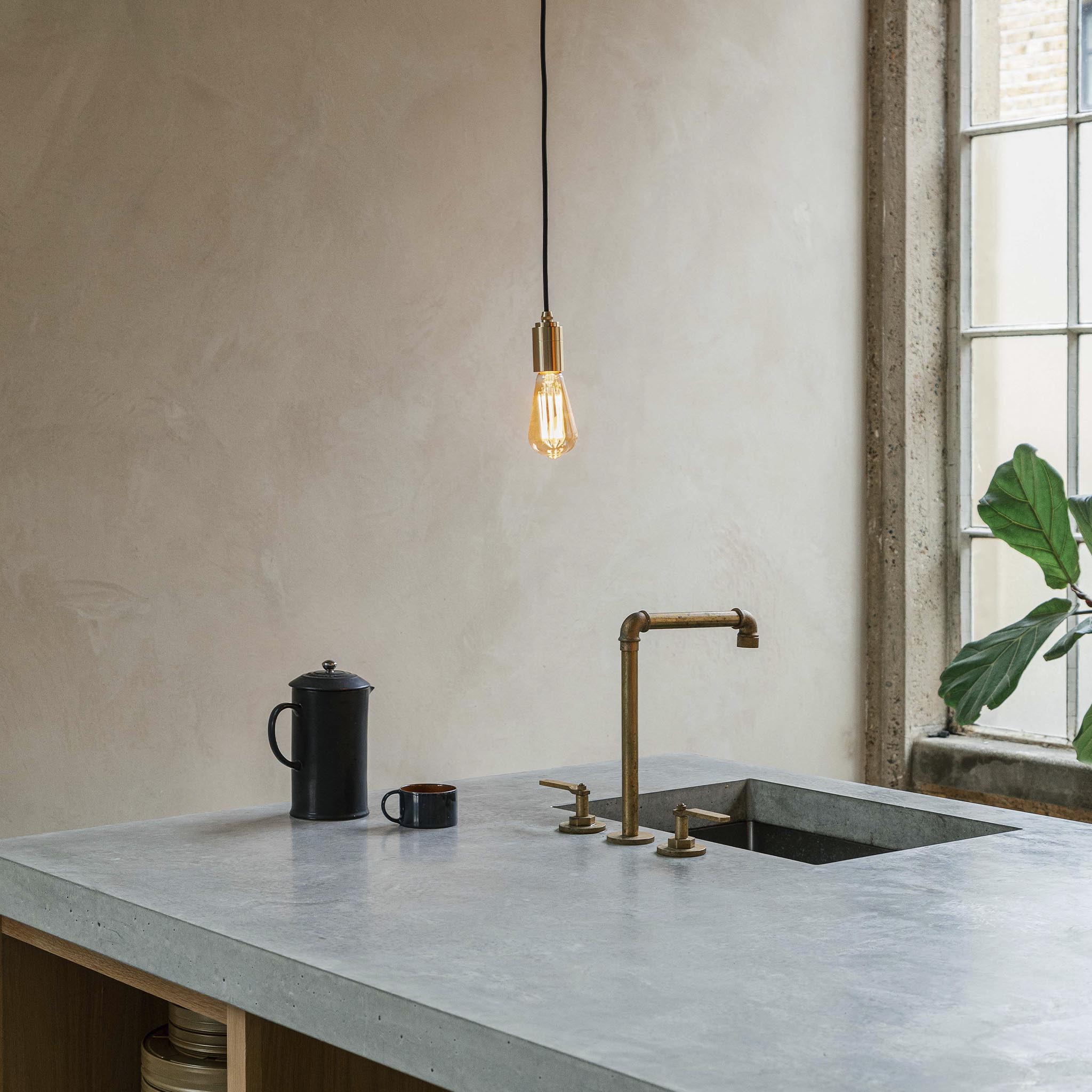 Tala Squirrel Cage Pendant Light in Brass in a styled interior setting