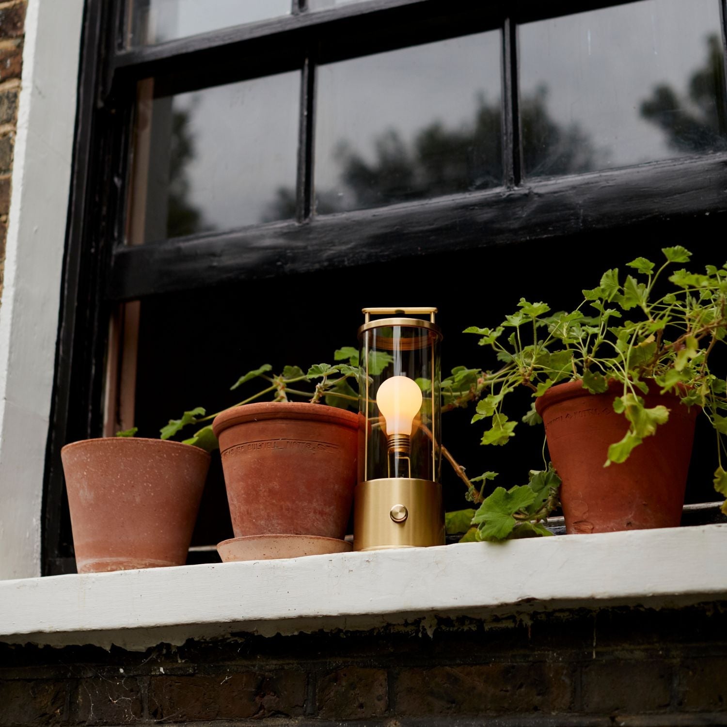 Tala The Muse 1.0 Portable Lamp in Solid Brass Bundle in a styled interior setting (view 2)