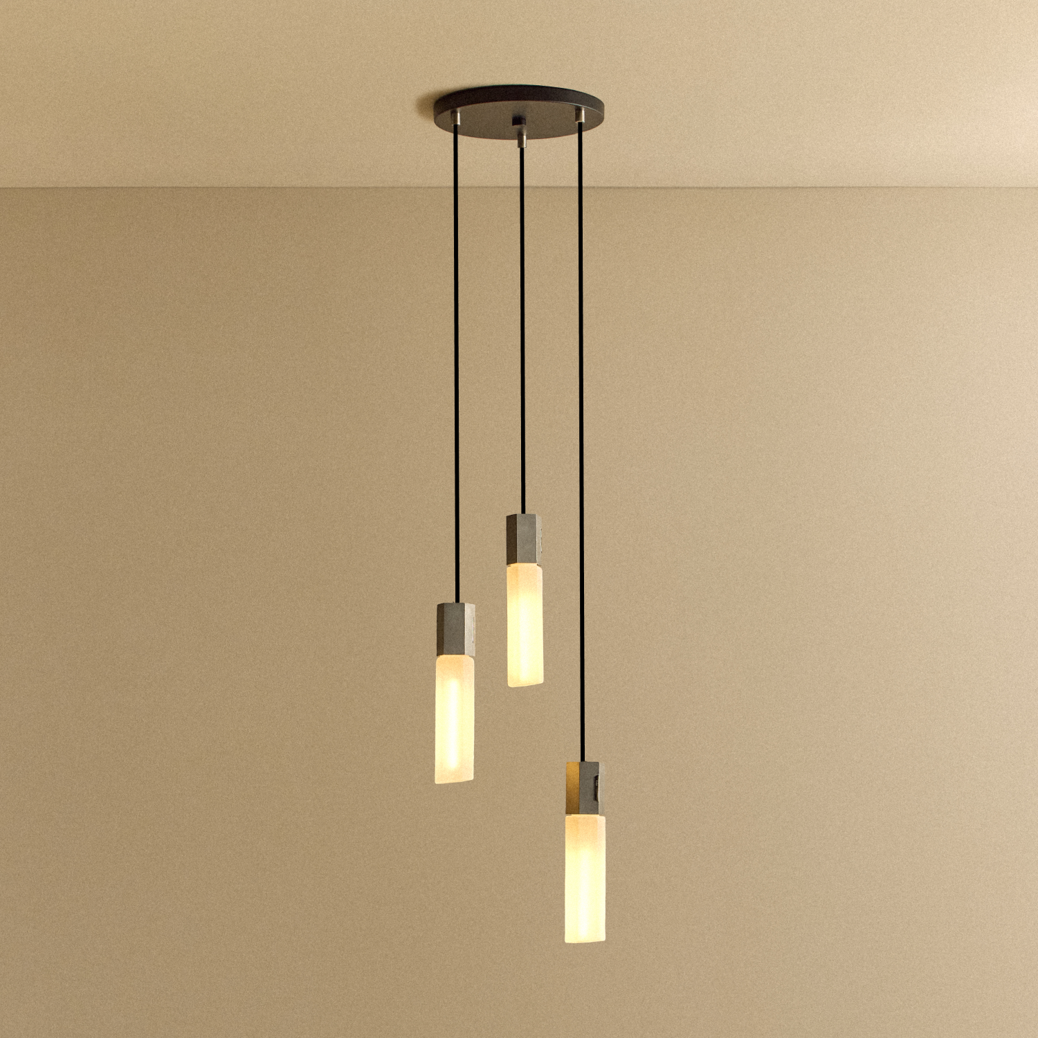 Tala Basalt Triple Pendant in Stainless Steel shown illuminated
