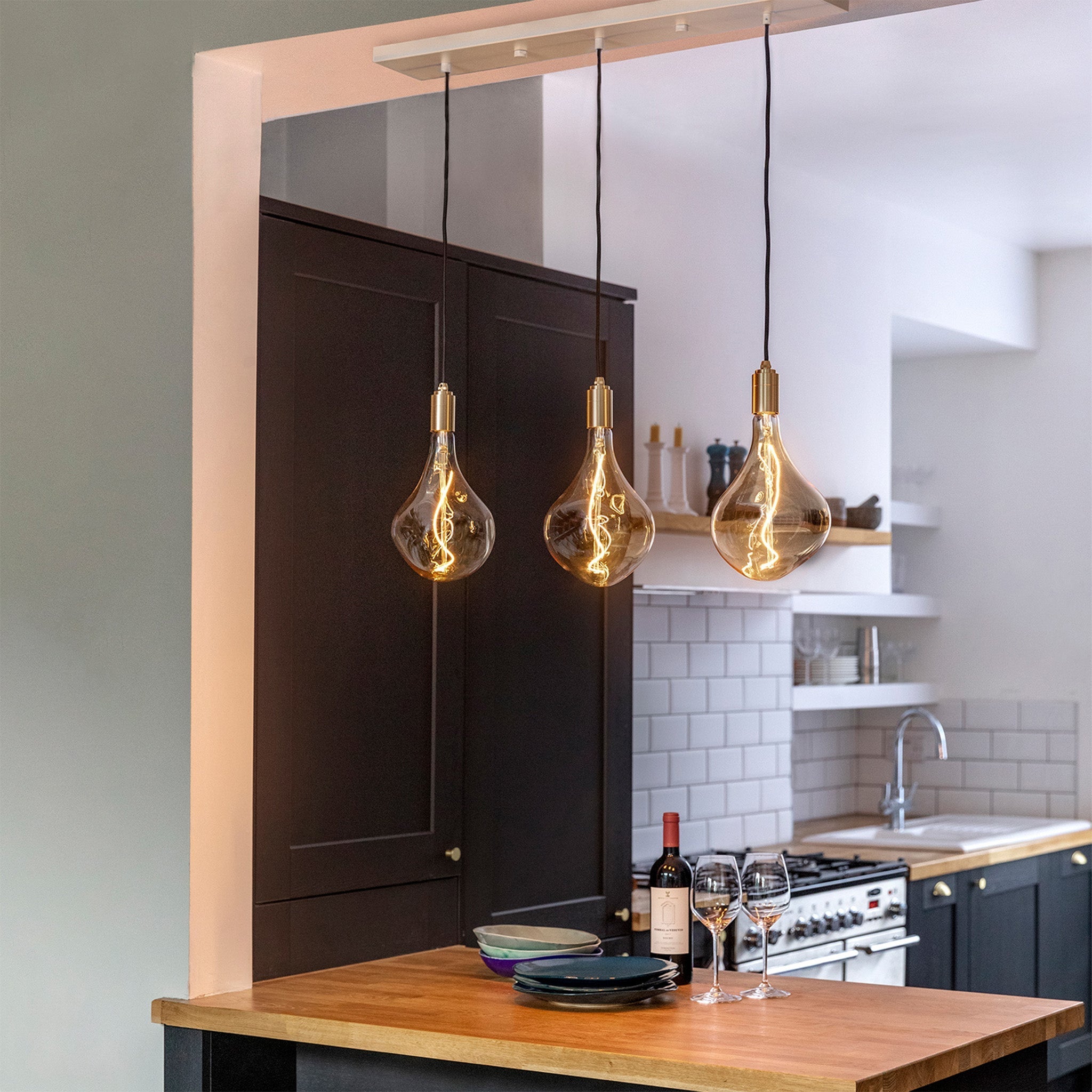 Tala Linear Triple Pendant in Brass in a styled interior setting (view 3)