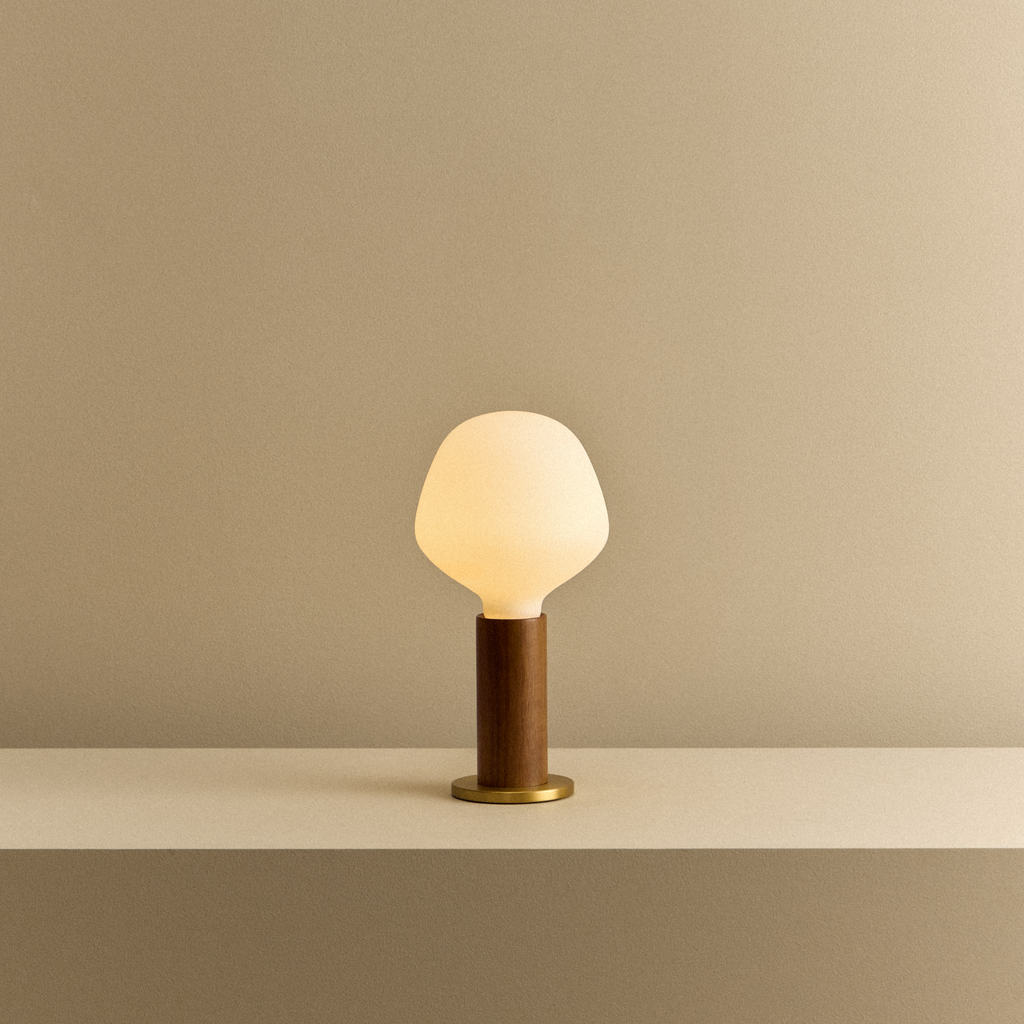 Tala Knuckle Table Lamp in Walnut + Enno shown illuminated