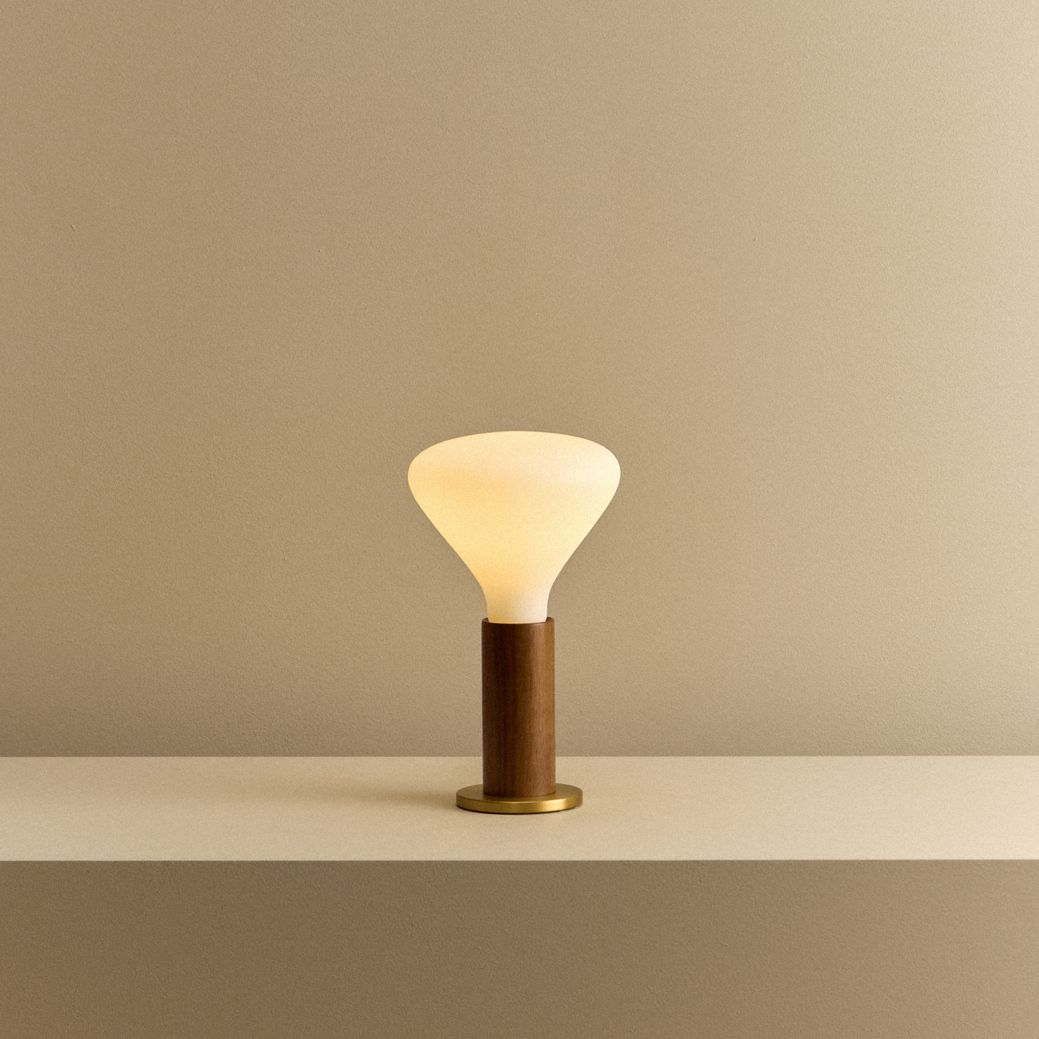 Tala Knuckle Table Lamp in Walnut + Noma shown illuminated