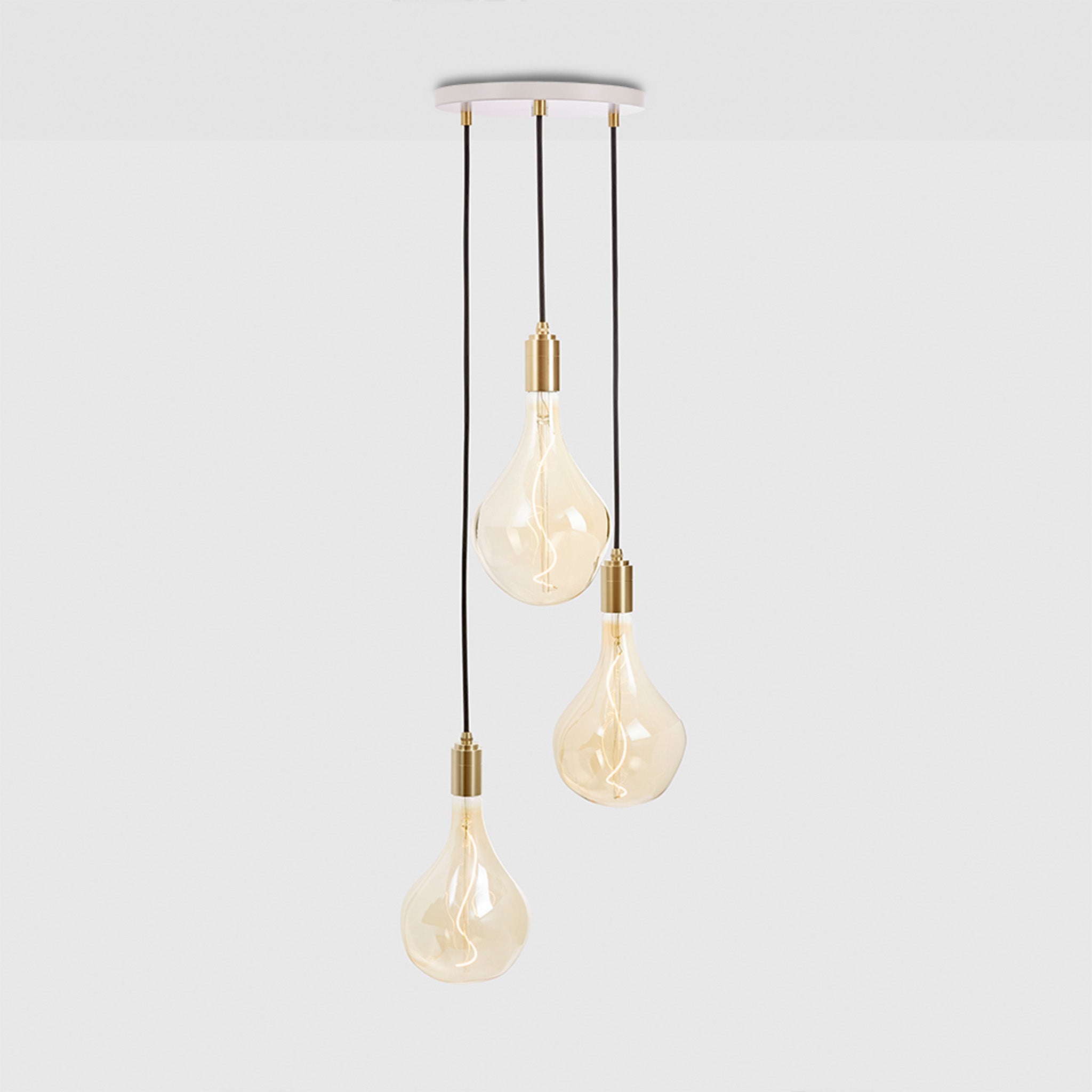 Tala Triple Pendant in Brass + Voronoi II shown illuminated (view 2)