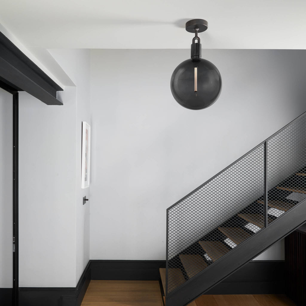 Buster + Punch Forked Ceiling Light Smoked Glass Globe Large styled in a luxury interior | Araco Interiors
