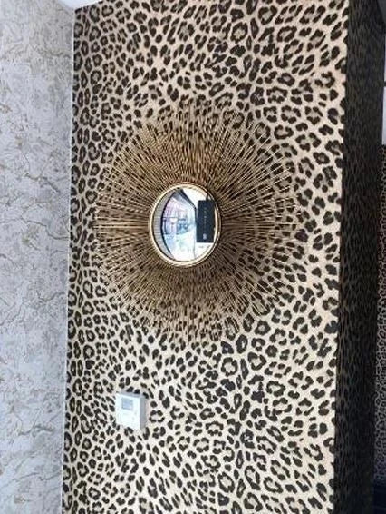 Eichholtz Solaris S gold finish mirror shown on a wall