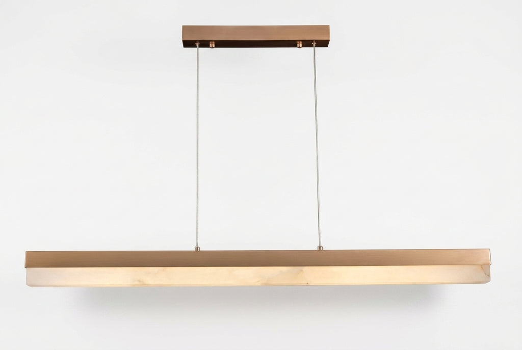 Araco Lumière Frozen Fira linear natural alabaster pendant light over a kitchen island