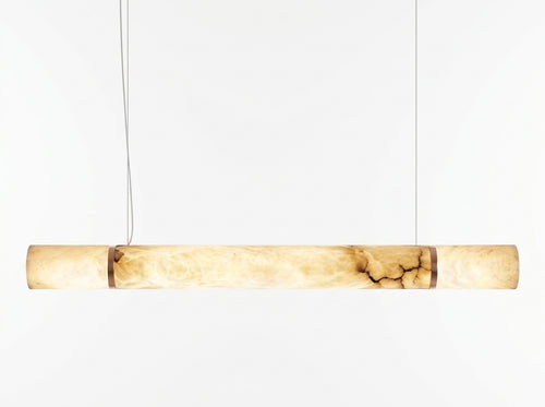 Araco Lumière Frozen Vox linear natural alabaster pendant light over a dining table