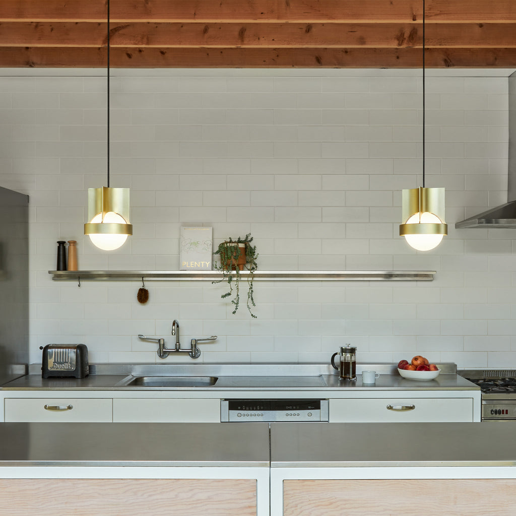 Tala Loop Single Pendant in Gold + Sphere IV in a styled interior setting (view 2)