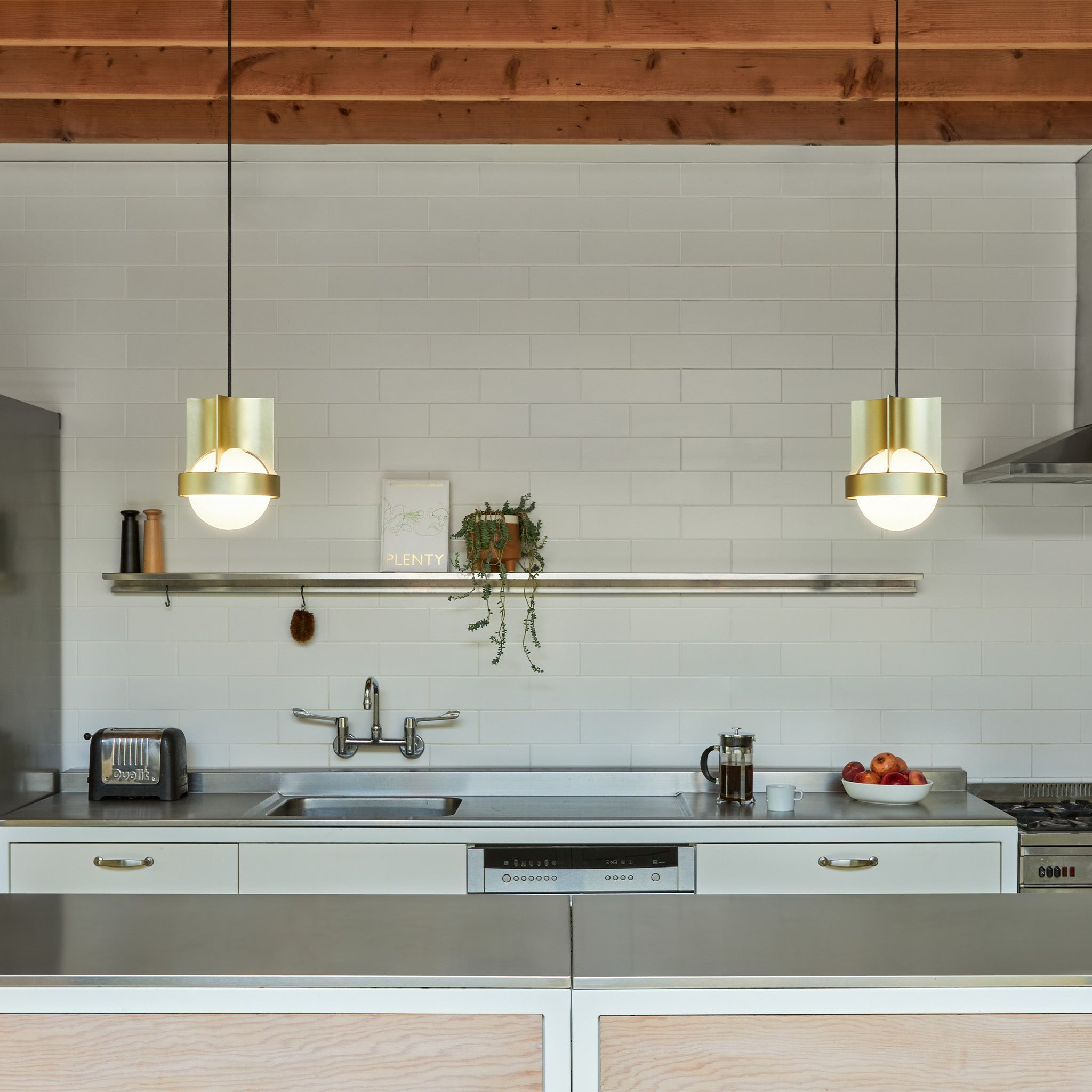 Tala Loop Single Pendant in Gold + Sphere IV in a styled interior setting (view 2)