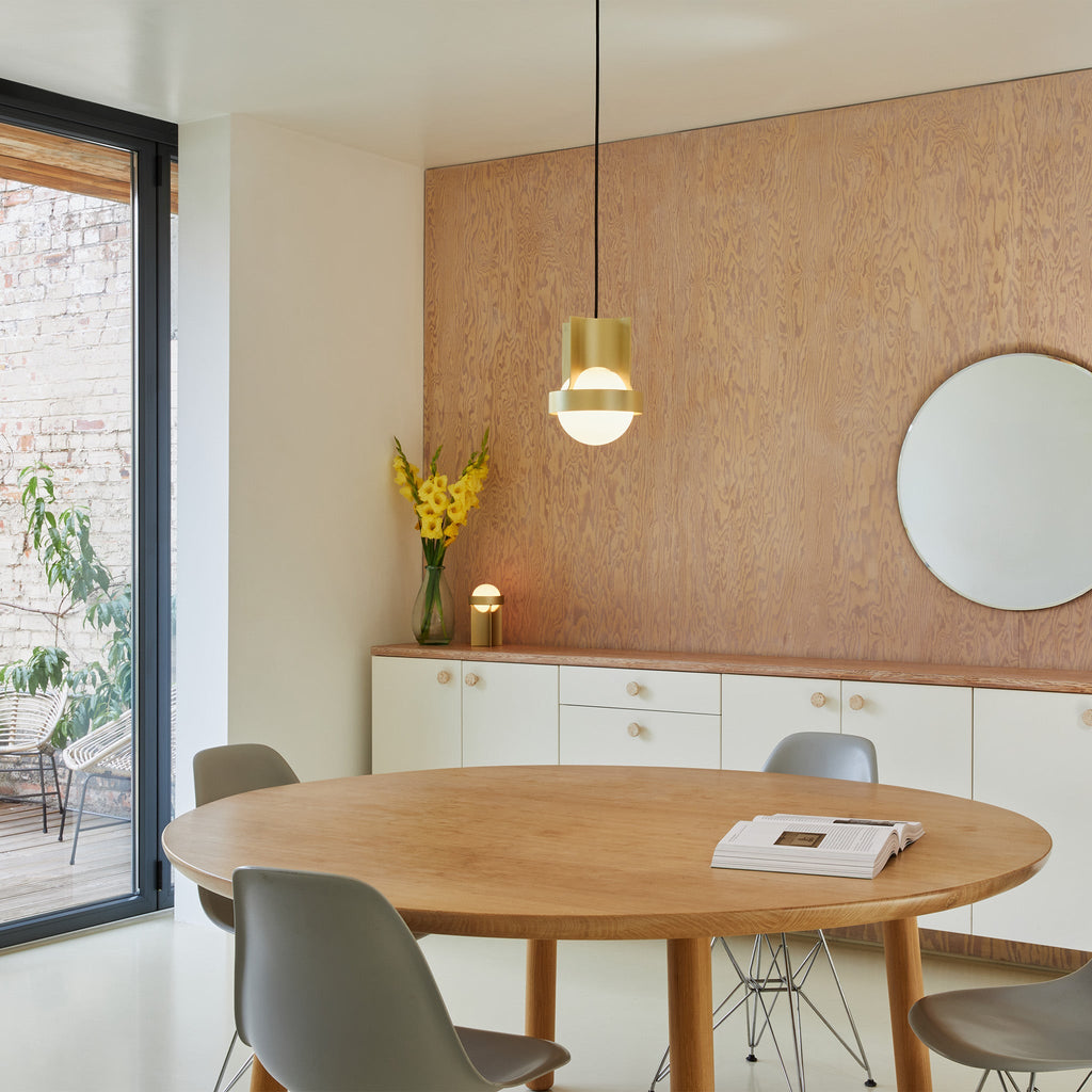 Tala Loop Single Pendant in Gold + Sphere IV in a styled interior setting