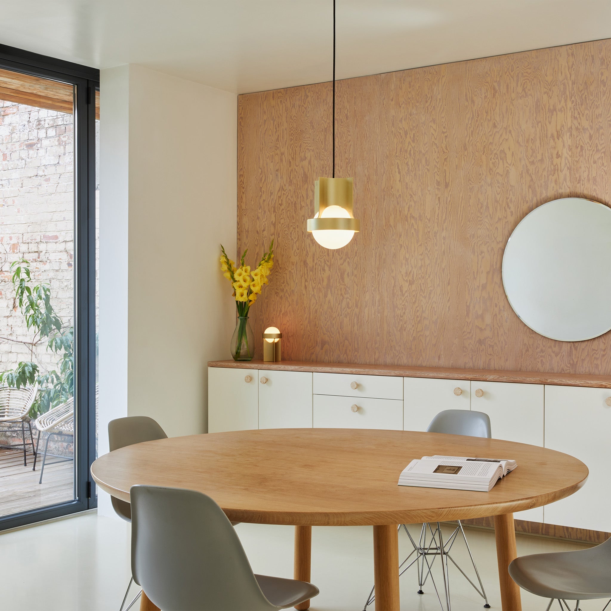 Tala Loop Single Pendant in Gold + Sphere IV in a styled interior setting