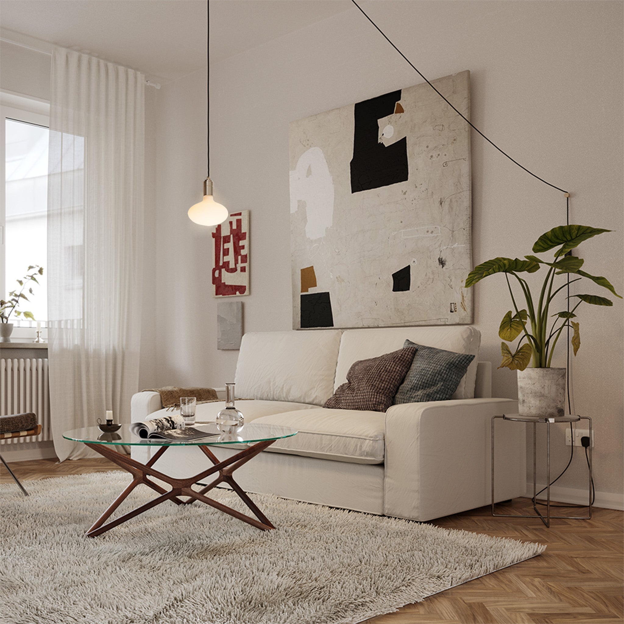 Tala Oval Plug-In Pendant in Brass in a styled interior setting