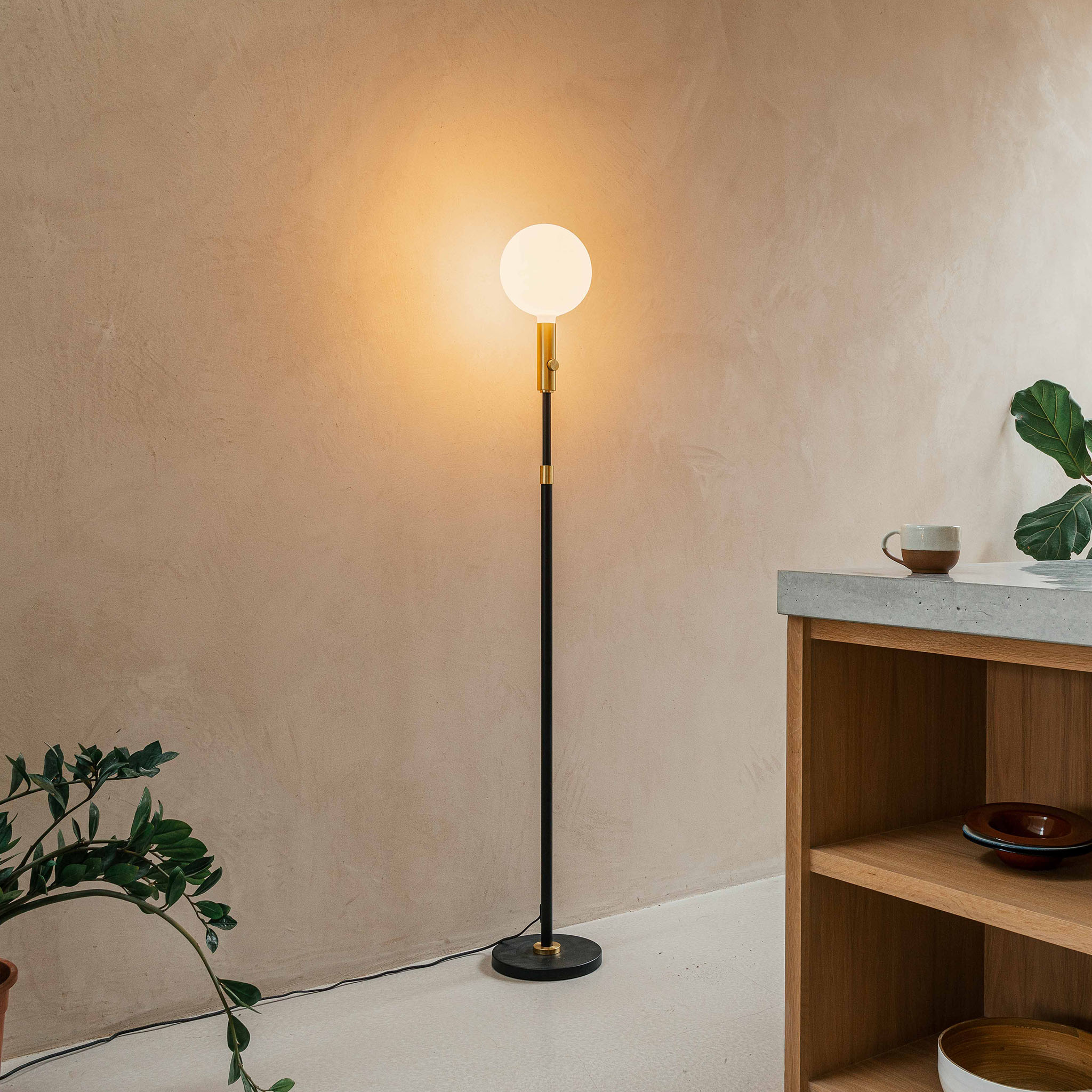 Tala Poise Adjustable Floor Lamp in Brass + Sphere V in a styled interior setting (view 3)